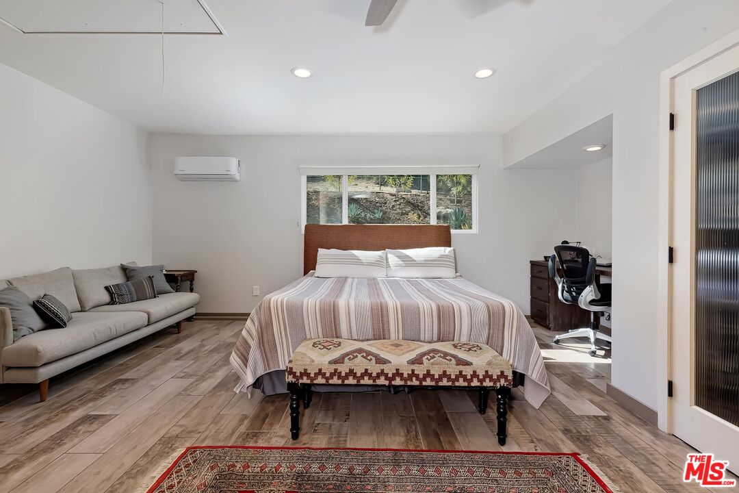 24537 Dry Canyon Cold Creek Road Calabasas, CA 91302 - Photo 32 of 54 a bedroom with a bed and a couch