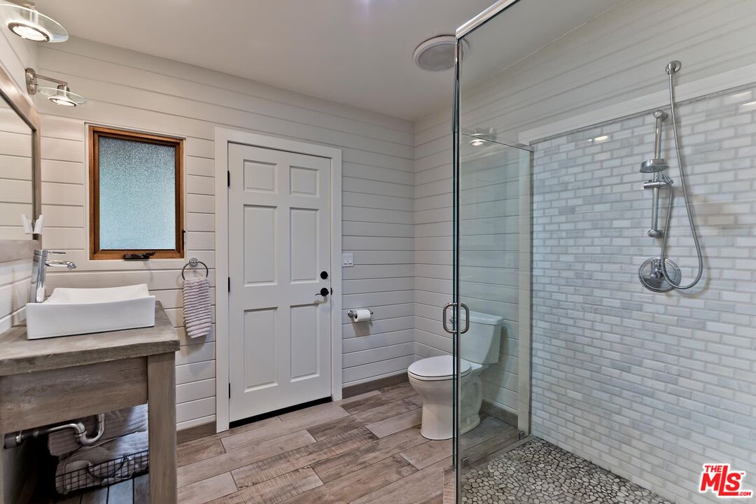 24537 Dry Canyon Cold Creek Road Calabasas, CA 91302 - Photo 33 of 54 a bathroom with a granite countertop sink a toilet and shower