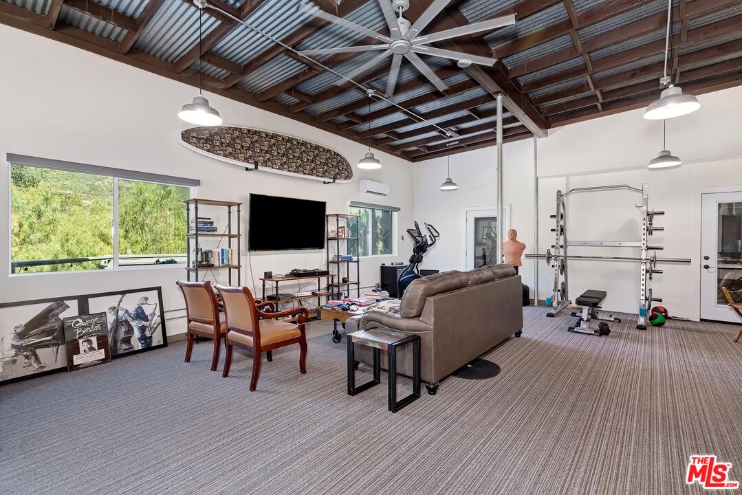 24537 Dry Canyon Cold Creek Road Calabasas, CA 91302 - Photo 36 of 54 a living room with furniture and a flat screen tv