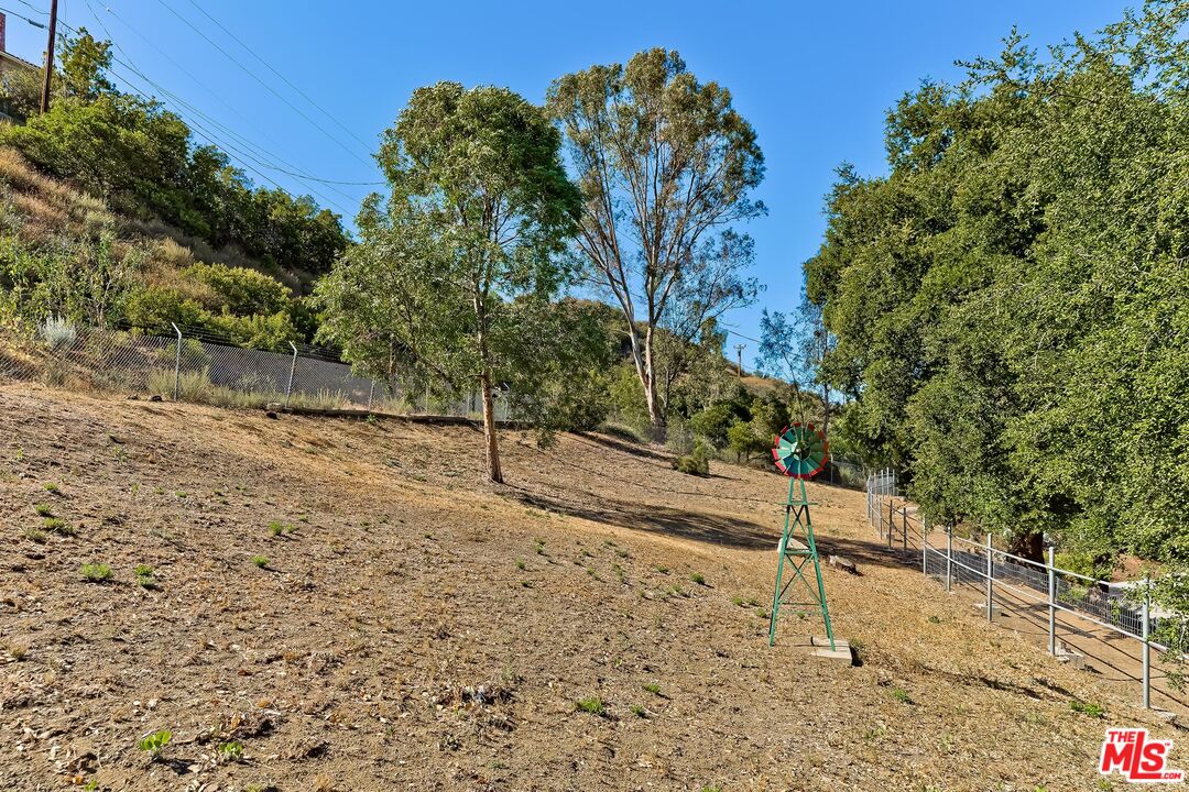 24537 Dry Canyon Cold Creek Road Calabasas, CA 91302 - Photo 39 of 54 a view of a yard with wooden fence