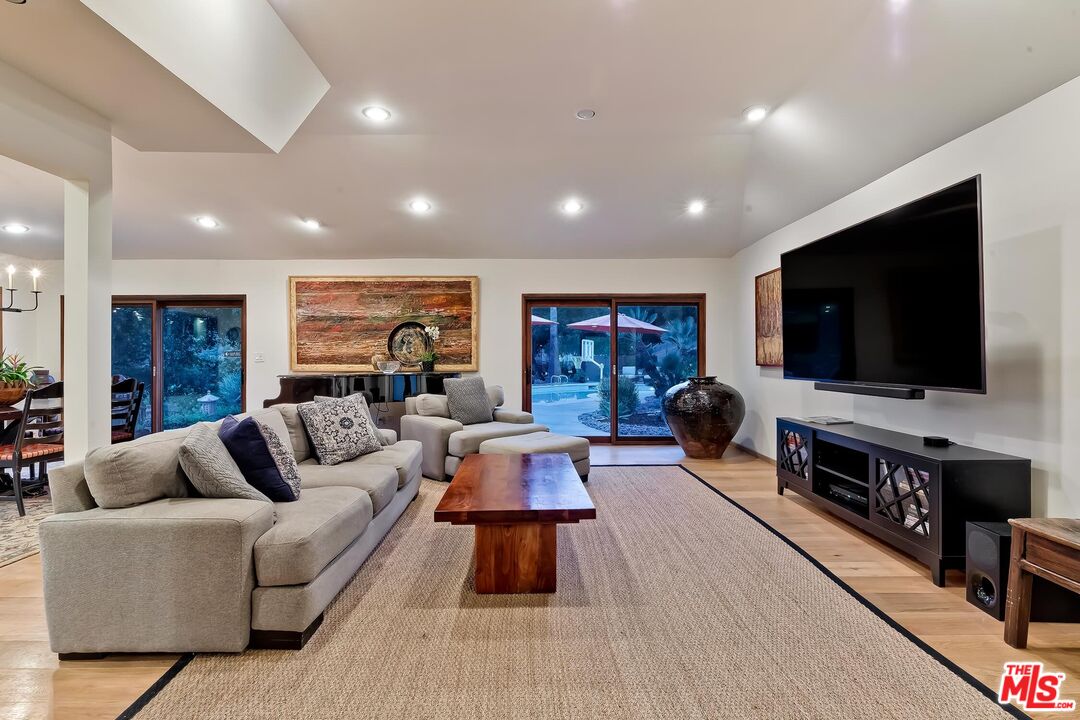 24537 Dry Canyon Cold Creek Road Calabasas, CA 91302 - Photo 40 of 54 a living room with furniture and a flat screen tv