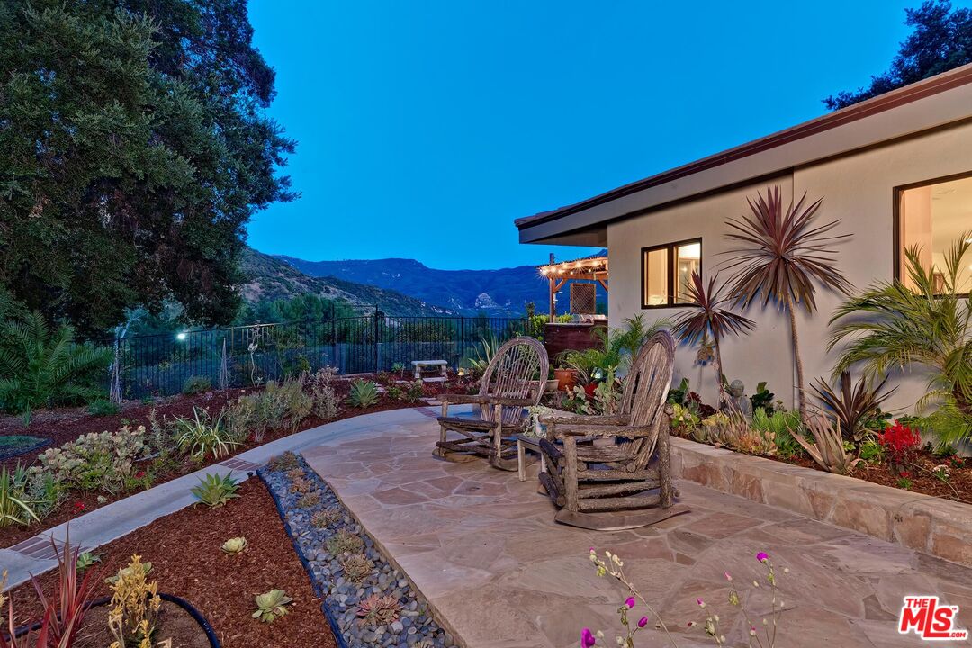 24537 Dry Canyon Cold Creek Road Calabasas, CA 91302 - Photo 4 of 54 a backyard of a house with a table and chairs