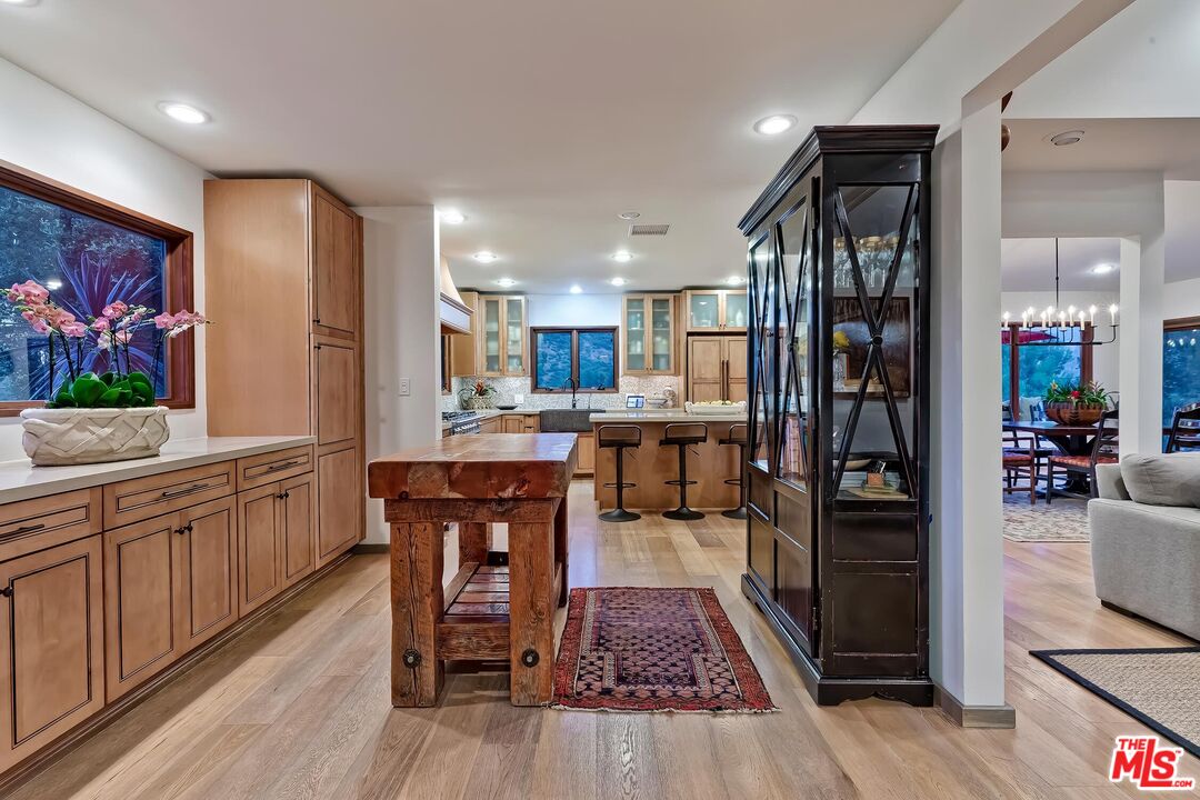 24537 Dry Canyon Cold Creek Road Calabasas, CA 91302 - Photo 43 of 54 a kitchen with stainless steel appliances granite countertop wooden floors a refrigerator and sink