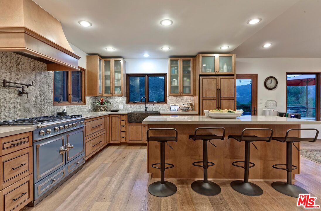 24537 Dry Canyon Cold Creek Road Calabasas, CA 91302 - Photo 44 of 54 a kitchen with stainless steel appliances granite countertop a stove a sink and a refrigerator