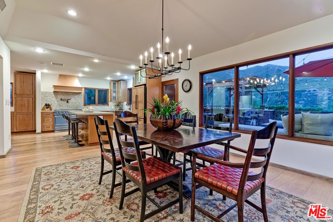 24537 Dry Canyon Cold Creek Road Calabasas, CA 91302 - Photo 46 of 54 a view of a dining room with furniture wooden floor and chandelier
