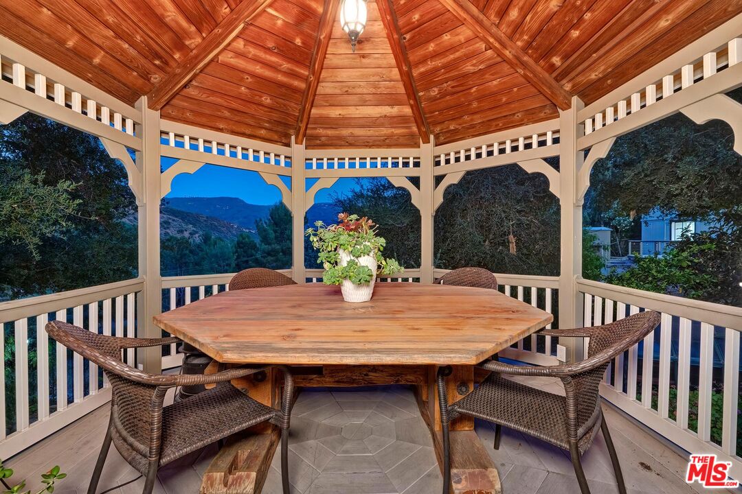 24537 Dry Canyon Cold Creek Road Calabasas, CA 91302 - Photo 50 of 54 a view of a tables and chairs in patio