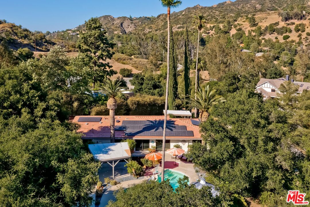 24537 Dry Canyon Cold Creek Road Calabasas, CA 91302 - Photo 51 of 54 an aerial view of a house with a yard and large trees