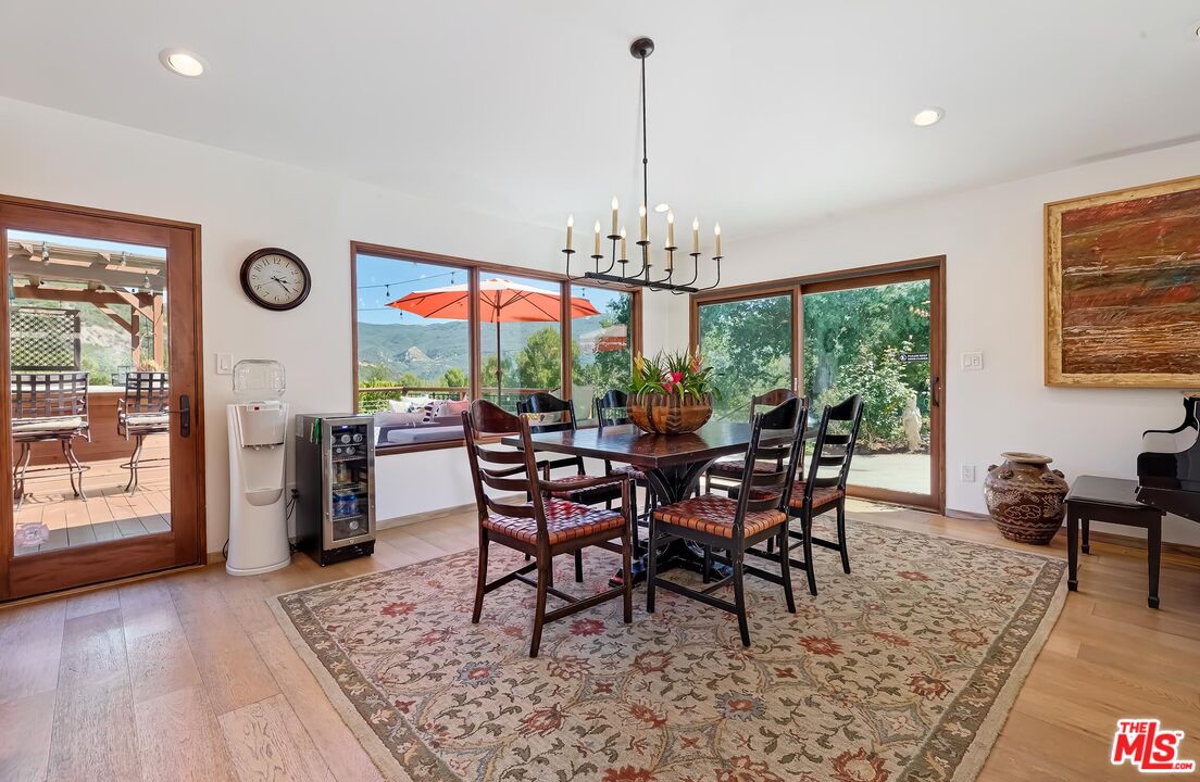 24537 Dry Canyon Cold Creek Road Calabasas, CA 91302 - Photo 10 of 54 a view of a dining room with furniture window and wooden floor