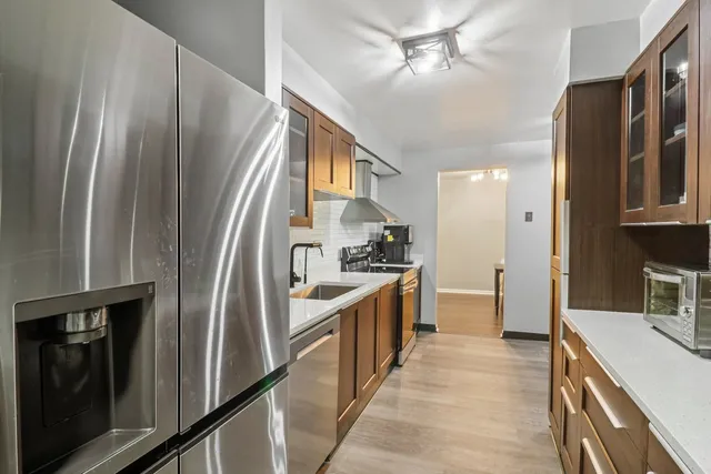 a kitchen with a sink stove and refrigerator