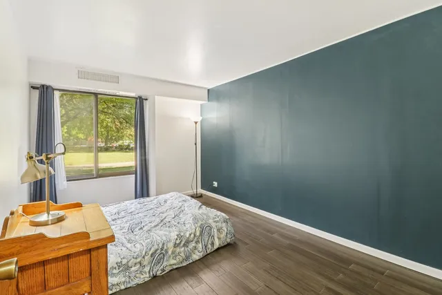 a bedroom with a bed and a desk