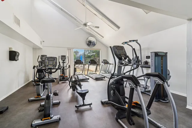 a living room with furniture a fireplace and a large window