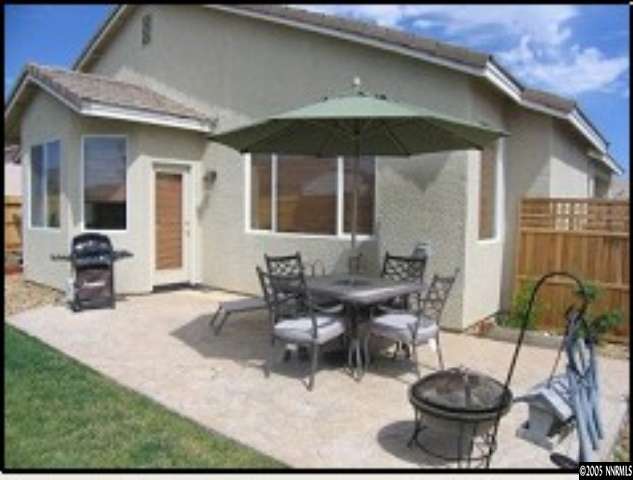 1798 Trek Trail Reno, NV 89521 - Photo 6 of 7 a view of a patio with table and chairs under an umbrella