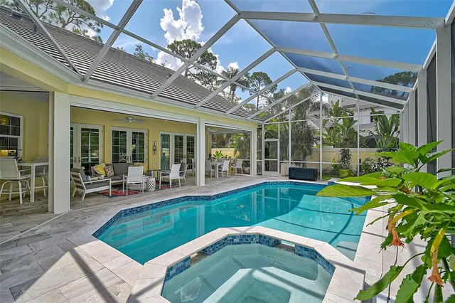a view of a house with a small yard and a large tree