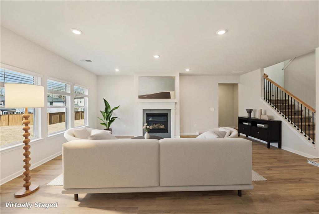 4412 Brick Tunl Street Powder Springs, GA 30127 - Photo 14 of 72 a living room with furniture fireplace and wooden floor