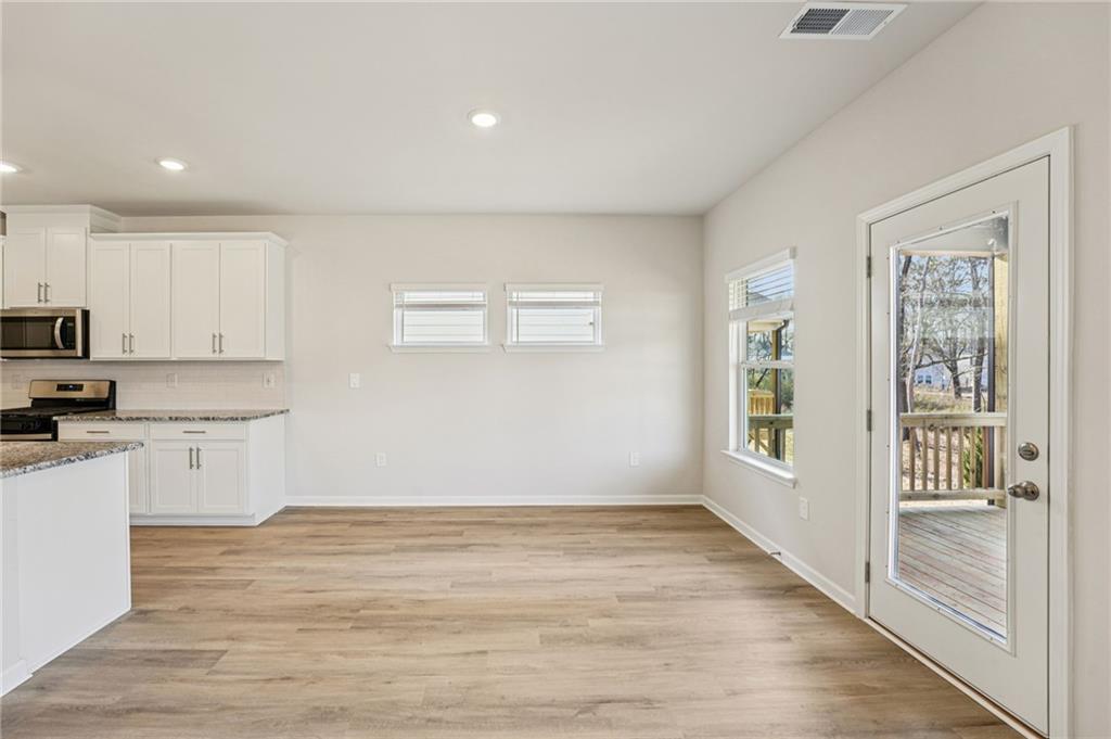 4412 Brick Tunl Street Powder Springs, GA 30127 - Photo 17 of 72 a view of a kitchen with wooden floor and a sink