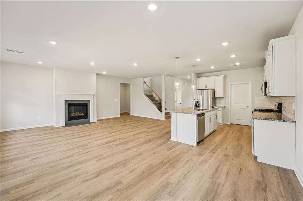 4412 Brick Tunl Street Powder Springs, GA 30127 - Photo 20 of 72 a large kitchen with a large counter top appliances and cabinets