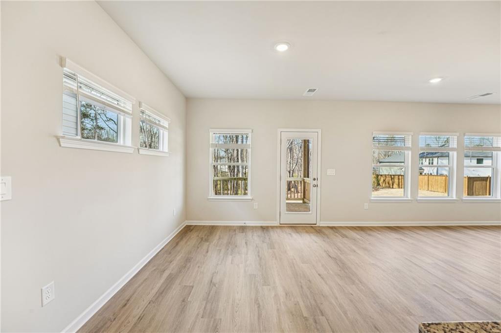 4412 Brick Tunl Street Powder Springs, GA 30127 - Photo 21 of 72 a view of an empty room with a window and wooden floor