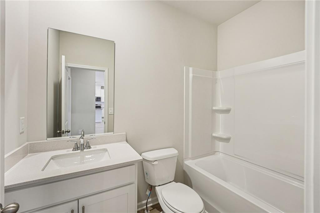 4412 Brick Tunl Street Powder Springs, GA 30127 - Photo 35 of 72 a bathroom with a sink toilet vanity and tub