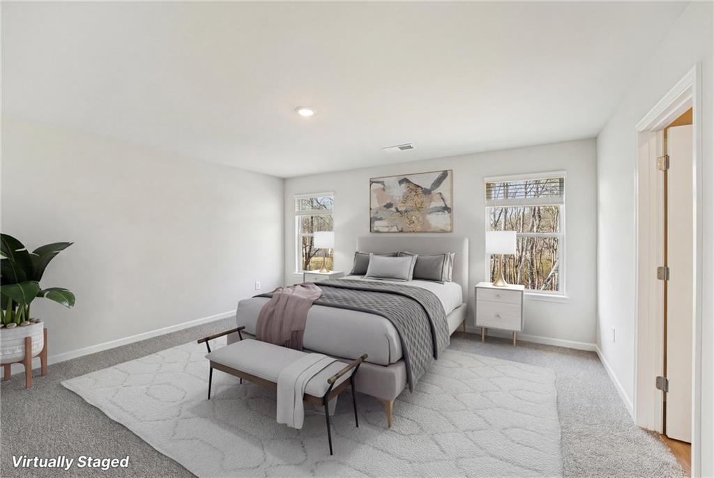 4412 Brick Tunl Street Powder Springs, GA 30127 - Photo 44 of 72 a bedroom with a bed and a painting on the wall