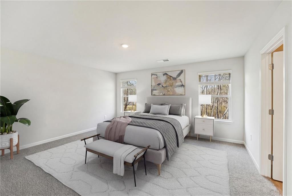 4412 Brick Tunl Street Powder Springs, GA 30127 - Photo 45 of 72 a bedroom with a bed and a couch