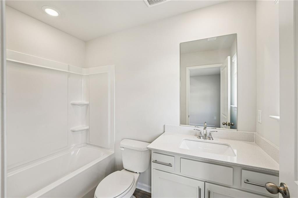 4412 Brick Tunl Street Powder Springs, GA 30127 - Photo 54 of 72 a bathroom with a sink toilet vanity and shower