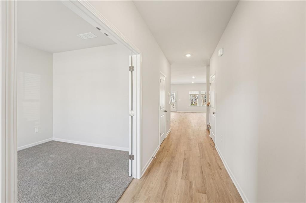 4412 Brick Tunl Street Powder Springs, GA 30127 - Photo 9 of 72 a view of a hallway with wooden floor