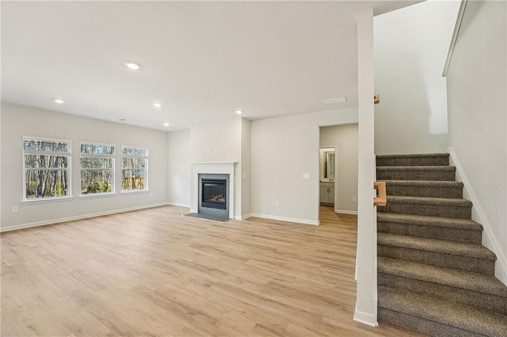 4412 Brick Tunl Street Powder Springs, GA 30127 - Photo 10 of 72 a view of an empty room with wooden floor and a window