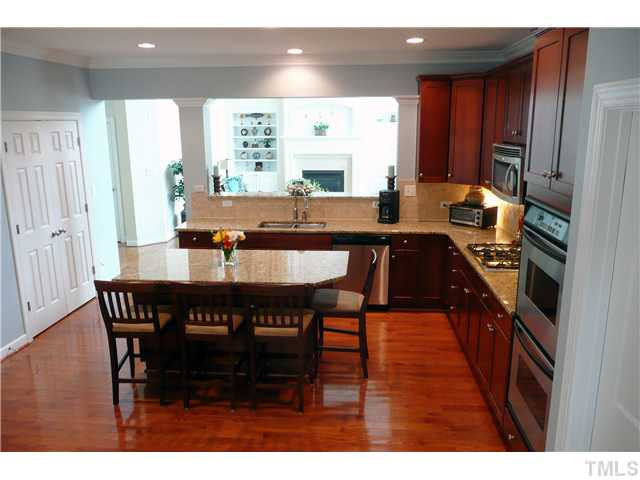 10504 Swerling Way Raleigh, NC 27614 - Photo 10 of 25 The kitchen also has cherry cabinets, under cabinet lighting, crown molding and a large walk-in pantry for all your food storage needs.. It opens to the breakfast area and family room. Kitchen