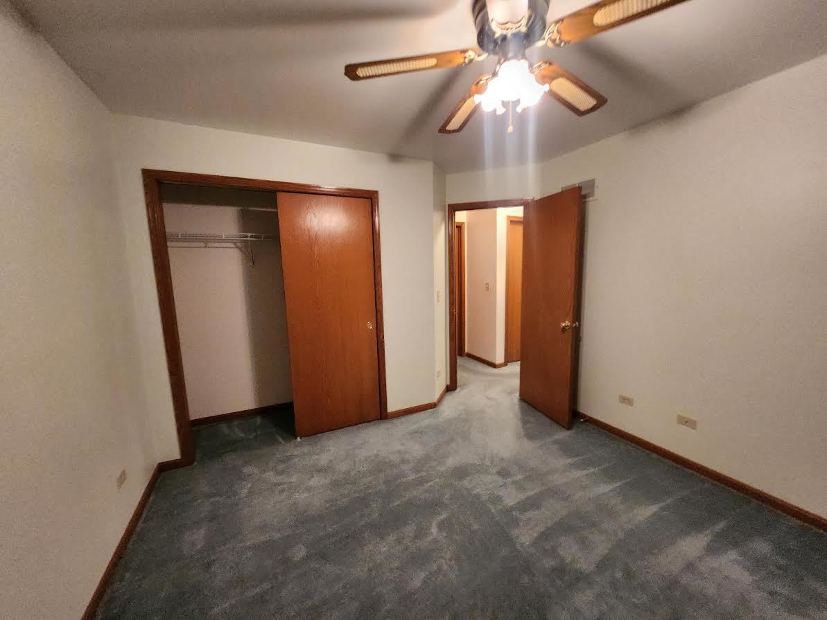 1819 Lake Shore Drive Romeoville, IL 60446 - Photo 12 of 16 an empty room with closet and a chandelier fan