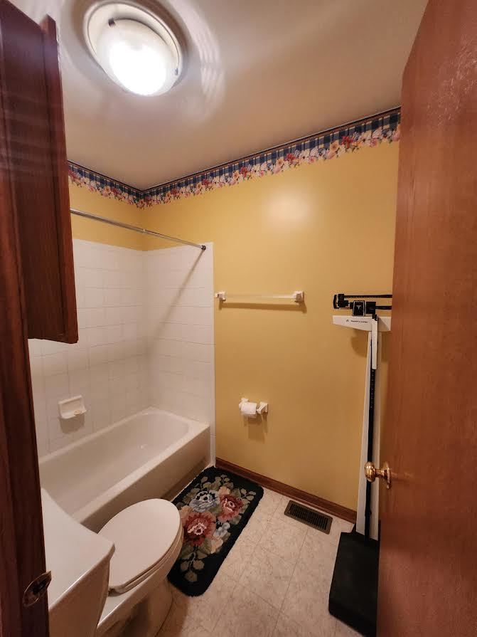 1819 Lake Shore Drive Romeoville, IL 60446 - Photo 13 of 16 a bathroom with a toilet and a shower