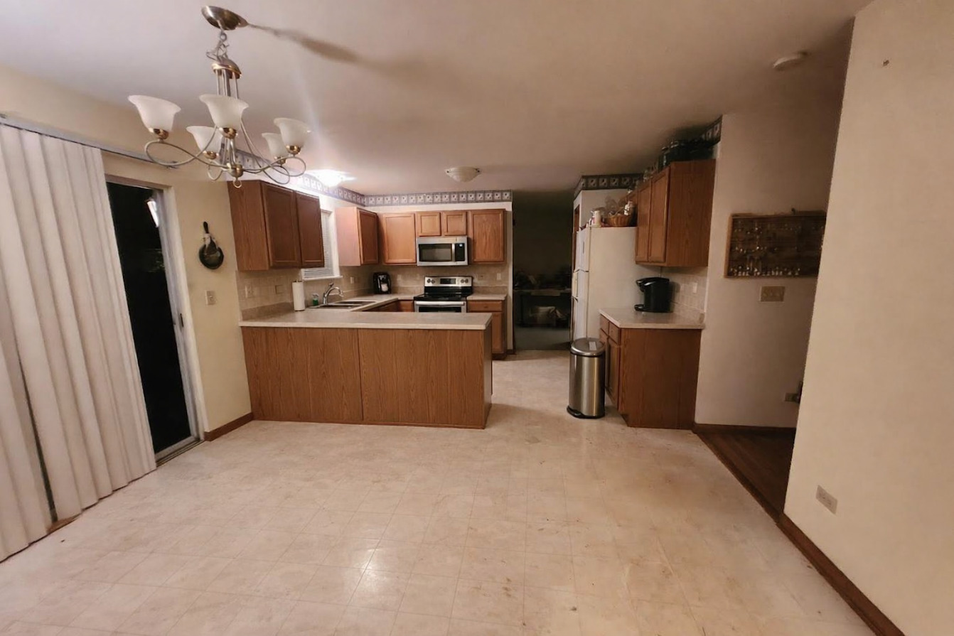 1819 Lake Shore Drive Romeoville, IL 60446 - Photo 2 of 16 a kitchen with stainless steel appliances a refrigerator a sink dishwasher a stove top oven a washer and dryer