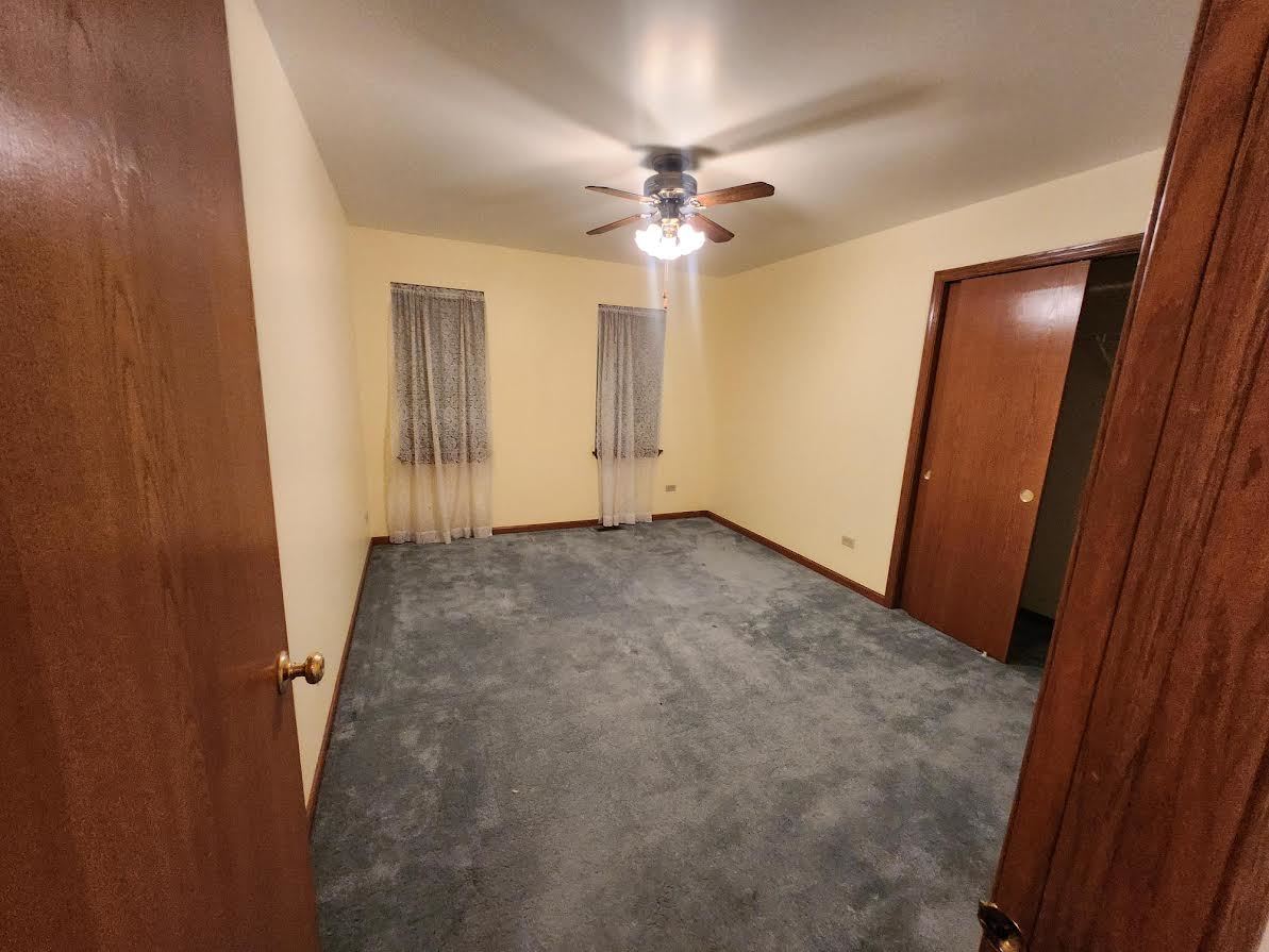 1819 Lake Shore Drive Romeoville, IL 60446 - Photo 3 of 16 an empty room with closet and a chandelier fan