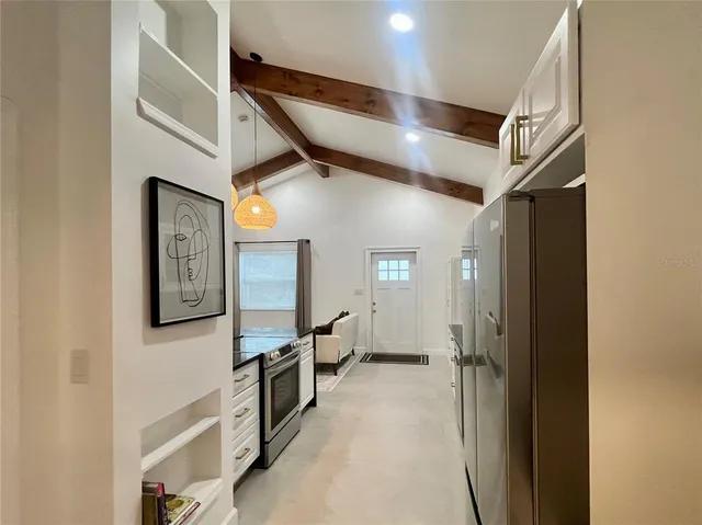 a view of hallway with stairs and wooden floor