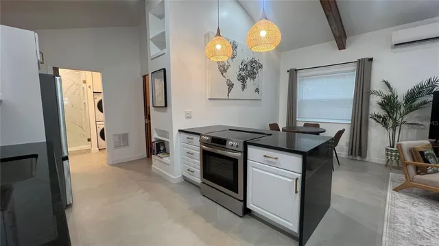 a kitchen that has a lot of cabinets a sink and a stove in it