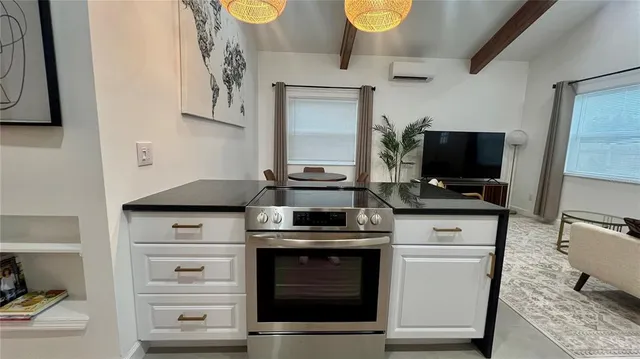 a kitchen with stainless steel appliances a stove and a microwave