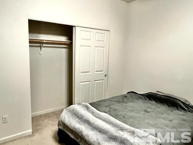 4335 Rancheria Road Fallon, NV 89406 - Photo 22 of 36 a bedroom with a bed and a refrigerator