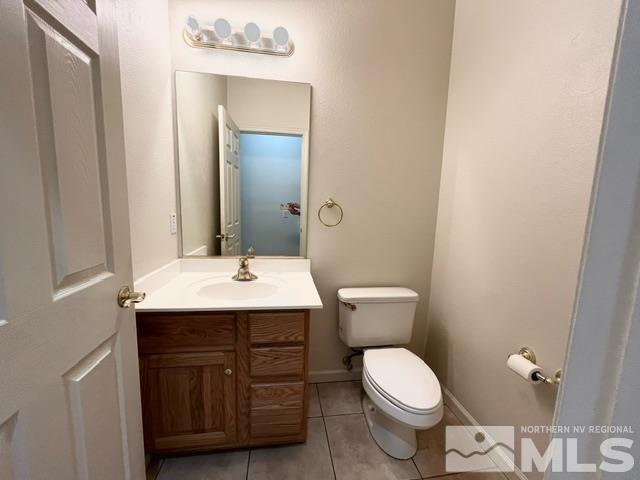 4335 Rancheria Road Fallon, NV 89406 - Photo 25 of 36 a bathroom with a toilet a sink and mirror