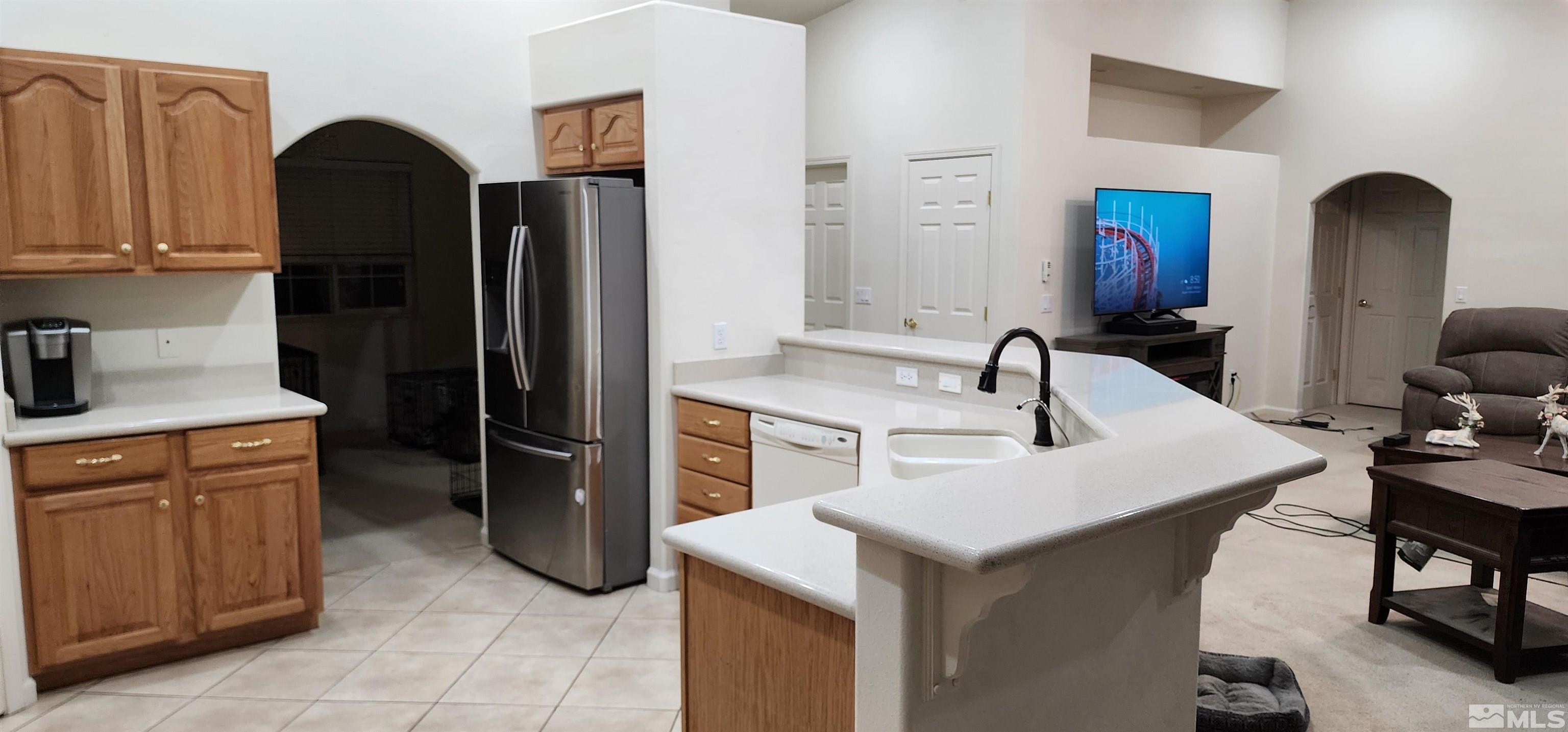 4335 Rancheria Road Fallon, NV 89406 - Photo 9 of 36 a kitchen with a refrigerator and a sink