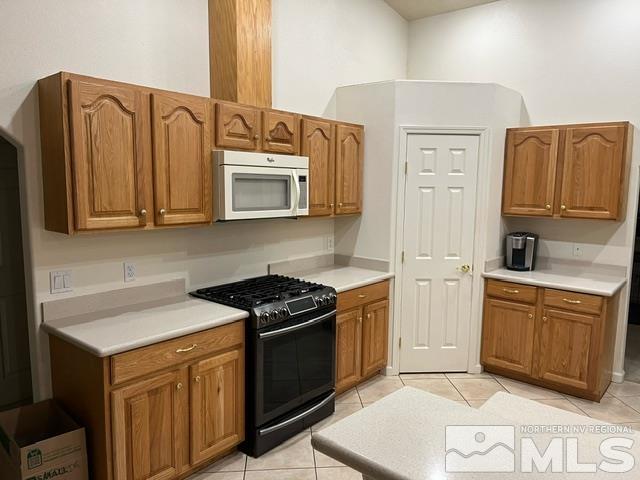 4335 Rancheria Road Fallon, NV 89406 - Photo 10 of 36 a kitchen with stainless steel appliances granite countertop a sink stove and microwave