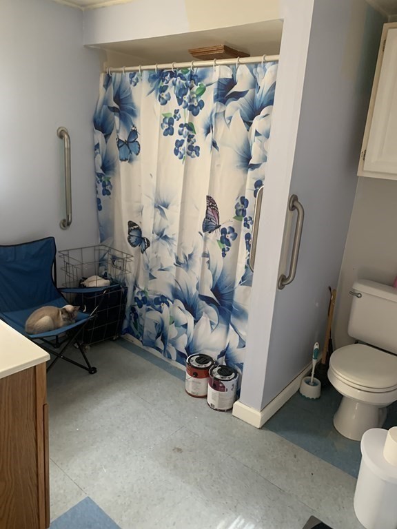 30-32 Stanley Street Lowell, MA 01850 - Photo 5 of 9 a living room with furniture and a toilet