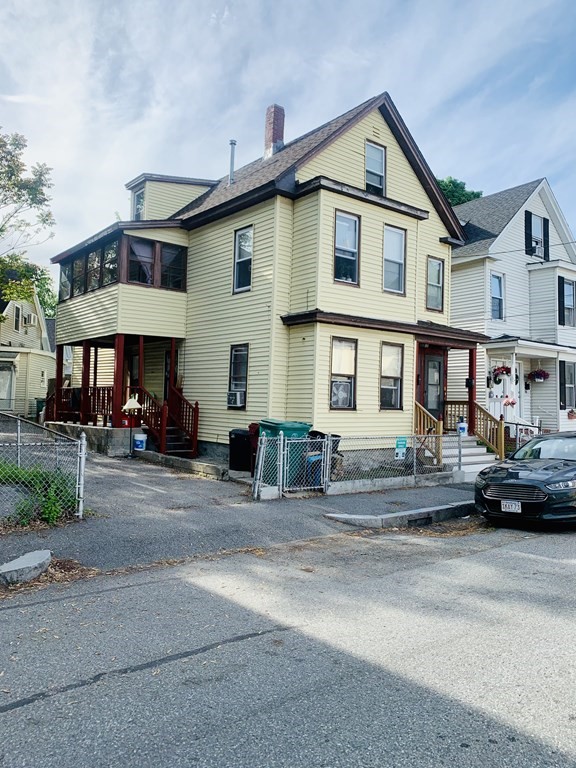 30-32 Stanley Street Lowell, MA 01850 - Photo 9 of 9 a front view of a house with a yard