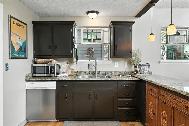 a kitchen with a sink and cabinets