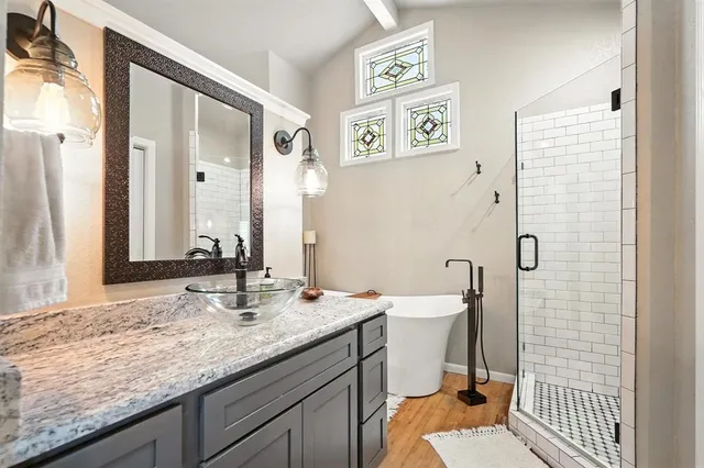 a bathroom with a granite countertop sink mirror vanity and toilet