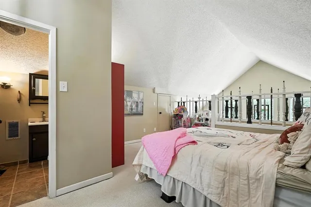 a bedroom with a bed and a large mirror