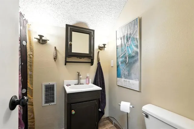 a bathroom with a sink a toilet and mirror