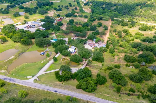 an aerial view of residential house with outdoor space and swimming pool