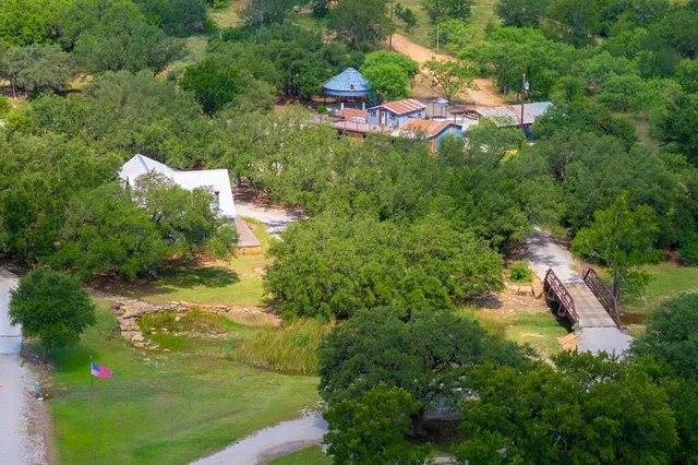an aerial view of a houses with yard