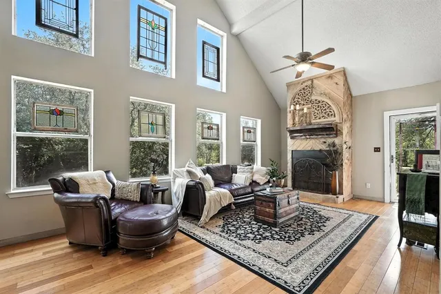 a living room with furniture a chandelier and a table