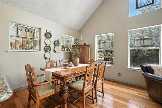 a view of a dining room with furniture window and wooden floor