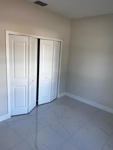 an empty room with closet area